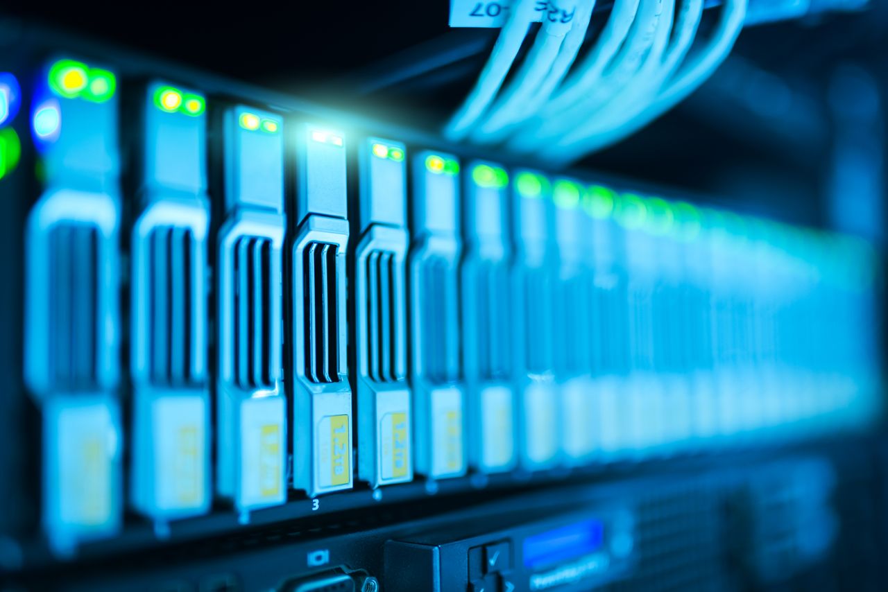 Services Detailed image of a server rack with glowing lights in a modern data center.