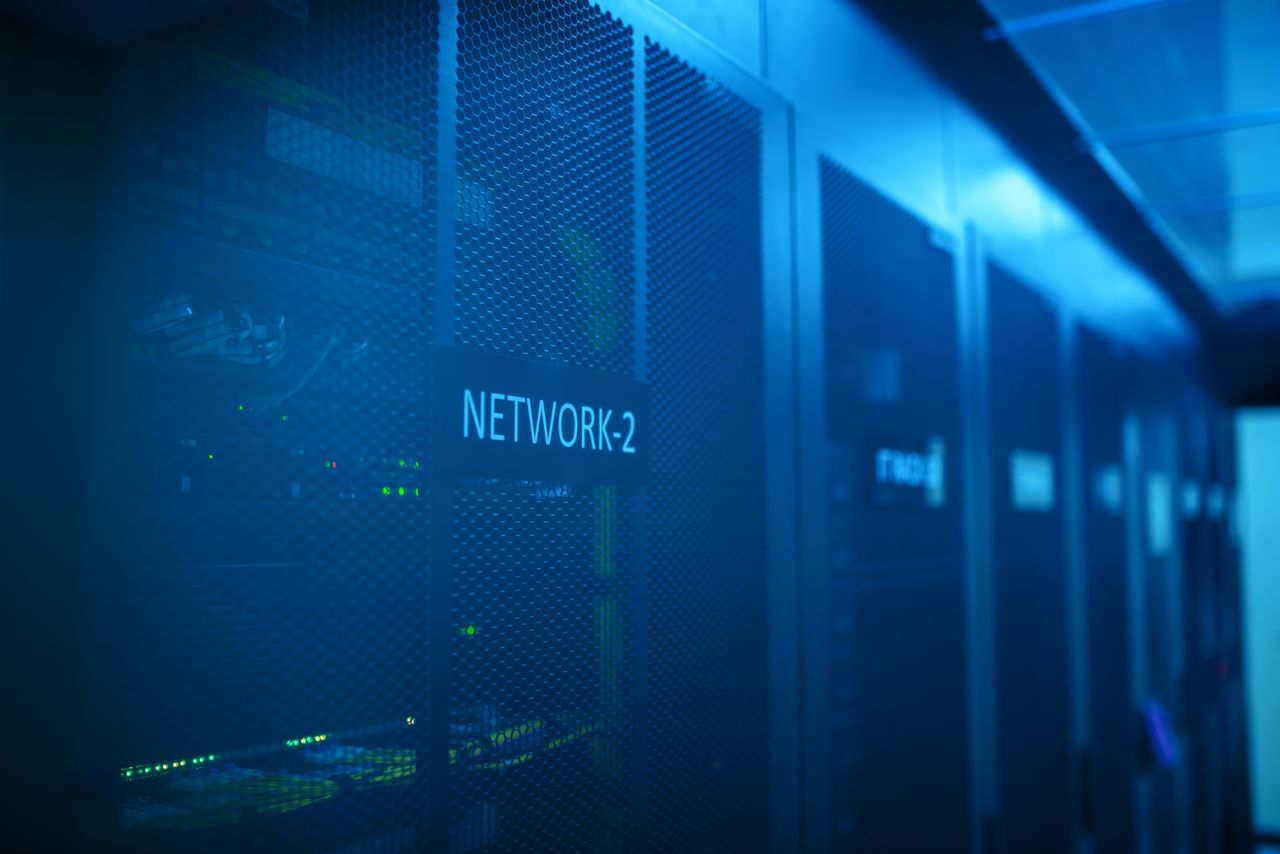 Home A modern server room featuring network equipment with blue illumination. Ideal for technology themes.
