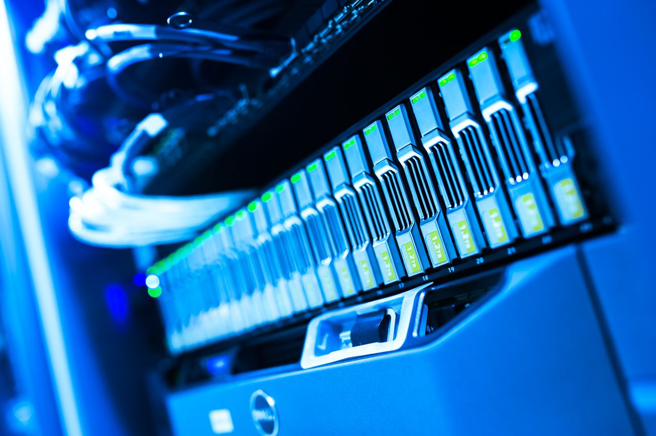 Services A detailed view of a blue lit computer server rack in a data center showcasing technology and hardware.