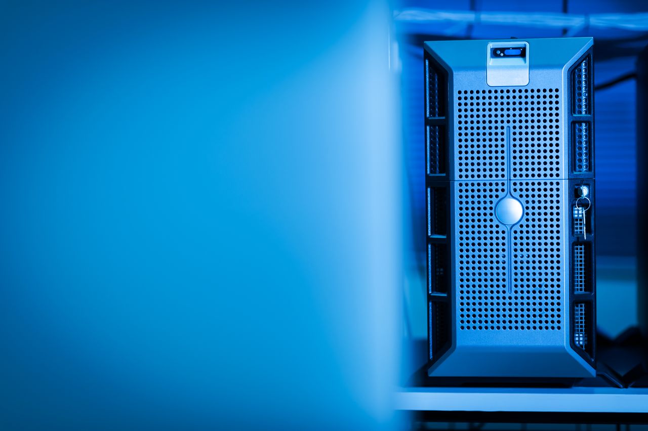 Home Close-up of a modern server unit in a blue-lit data center environment.