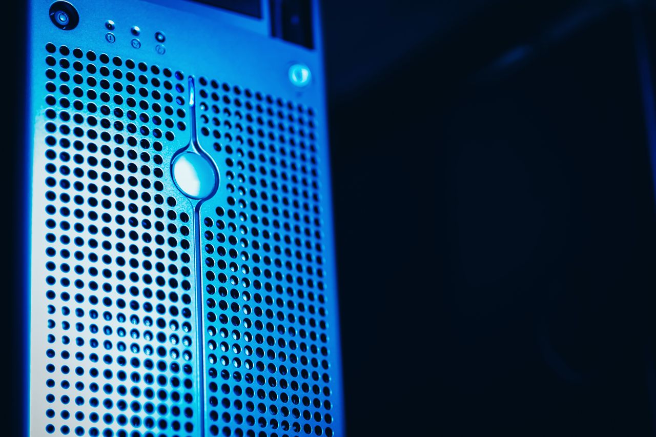 Home Modern server rack with blue lighting in a secure data center environment.